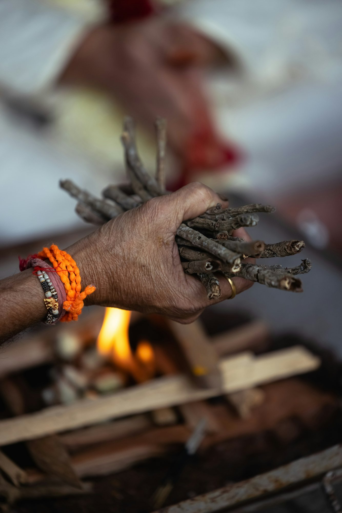 During an Indian wedding, a priest performs a ritual with fire and wood