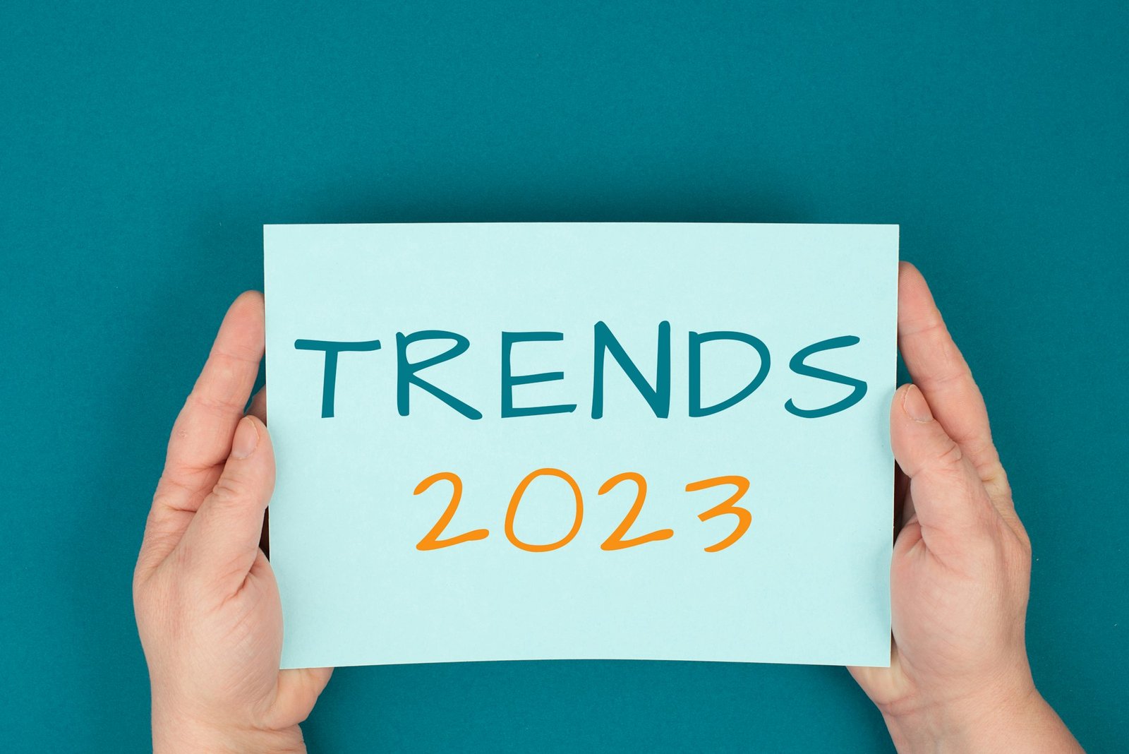 Trends 2023 is standing on a paper, hands holding the sign, communication, marketing, new concepts